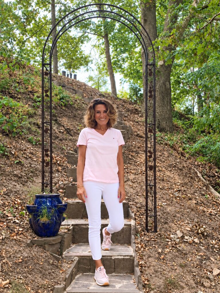 Nicole Rixgens mit ausgebreiteten Armen auf einer Steintreppe